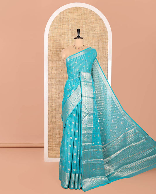 Rama Georgette Saree, Embellished with Peacock Buttas and Zari Checks All Over Its Body, Highlighted by a Traditional Zari Border, Grandly Zari-Decked Pallu, and Paired with a Matching Brocade Blouse