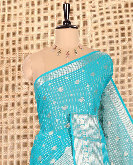 Rama Georgette Saree, Embellished with Peacock Buttas and Zari Checks All Over Its Body, Highlighted by a Traditional Zari Border, Grandly Zari-Decked Pallu, and Paired with a Matching Brocade Blouse