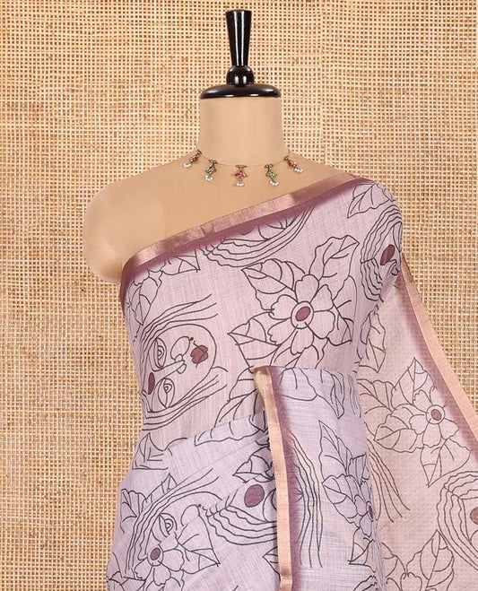 Light Mauve Linen Saree Creatively Printed with Girl Face and Floral Motifs All Over Its Body, Subtly Sparkled with Piping Zari Border, Pallu Mirrors the Same Body Print, and Paired with a Contrast Blouse