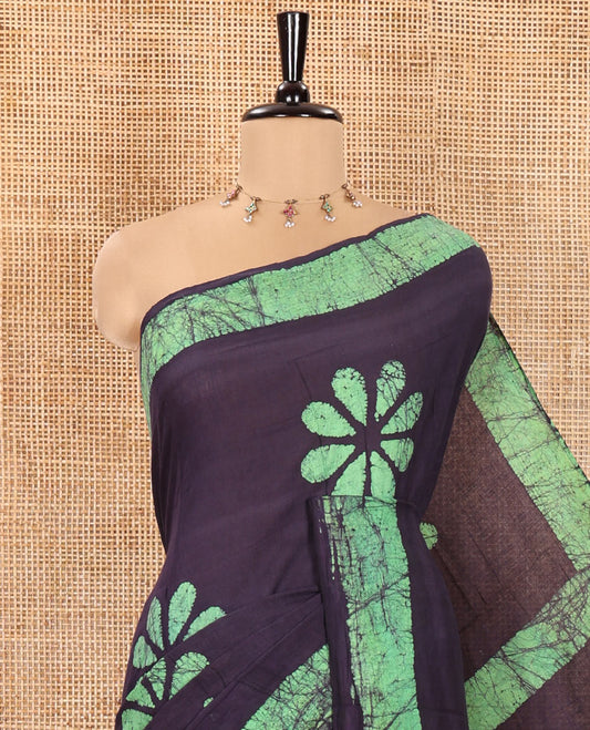 Blue Mul Cotton Saree Beautified with Batik-Style Floral Motifs Printed All Over Its Body, Complemented by a Contrast Batik Printed Border, Pallu Mirrors the Same Batik Print, and Is Paired with a Matching Blouse