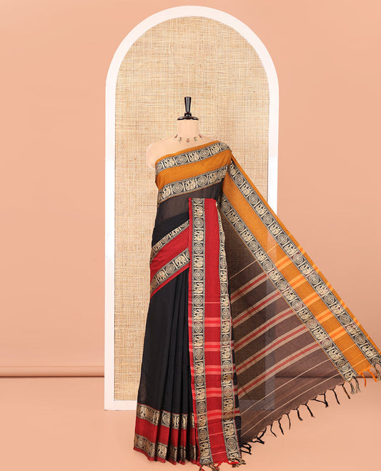 Black Plain Mercerised Cotton Saree, Complemented by a Contrast Ganga-Jamuna Rettai Pettu Thread Border of Temple, Elephant, and Chakram Designs, Subtly Striped Pallu, and Paired with a Matching Blouse