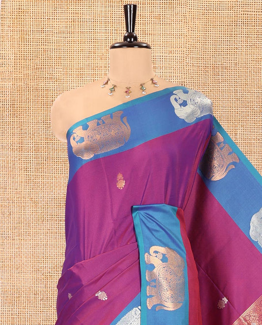 Purple Soft Silk Saree, Accentuated With Zari Buttas All Over Its Body, Complemented by Captivating Contrast Border of Elephant Motifs, Grandly Decked Up Pallu, and Paired with a Contrast Blouse