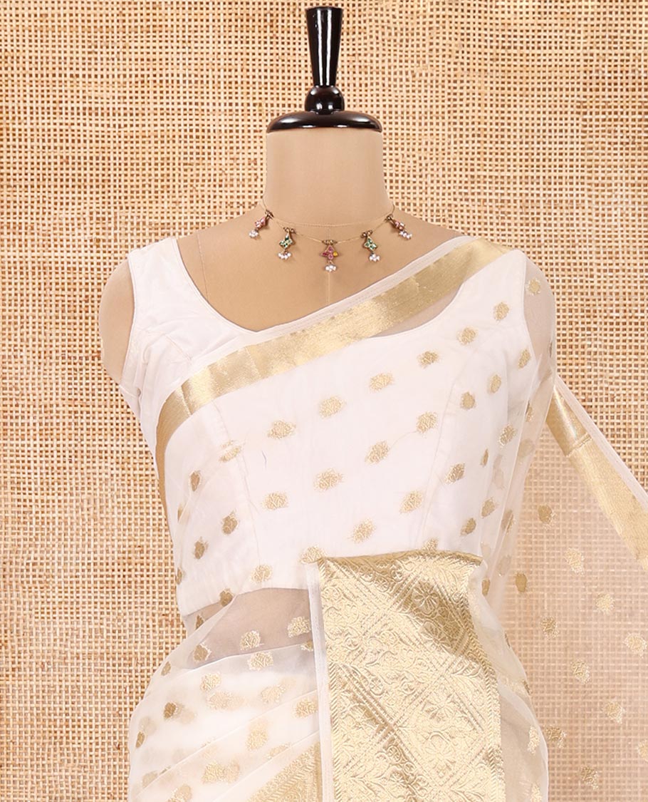 Cream Semi-Organza Saree, Mesmerized with Zari Buttas All Over Its Body, Highlighted by a Zari Jaal-Patterned Border, Gleaming Zari Design Pallu, and Paired with a Matching Blouse