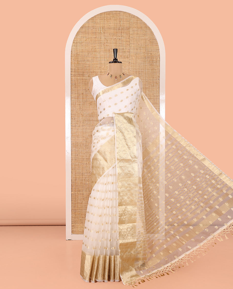 Cream Semi-Organza Saree, Mesmerized with Zari Buttas All Over Its Body, Highlighted by a Zari Jaal-Patterned Border, Gleaming Zari Design Pallu, and Paired with a Matching Blouse