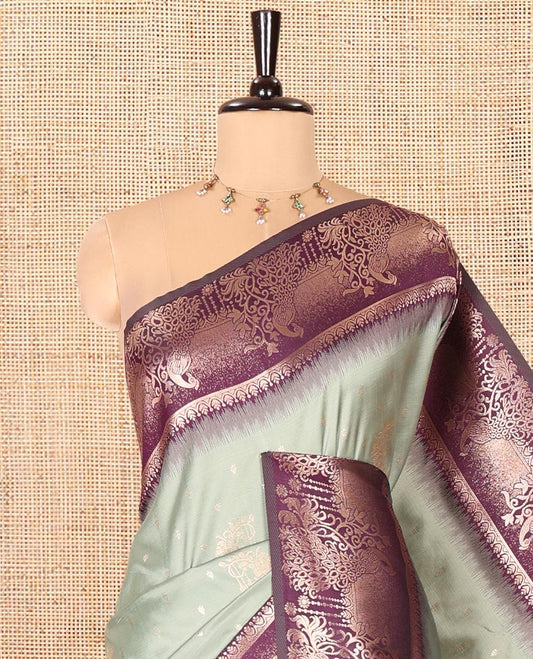 Pista Green Elite Soft Silk Saree, Featuring Zari Buttas on Its Body, Complemented by a Contrast Peacock-Floral Zari Blouse, Intricately Designed Pallu, and Paired with a Contrast Blouse