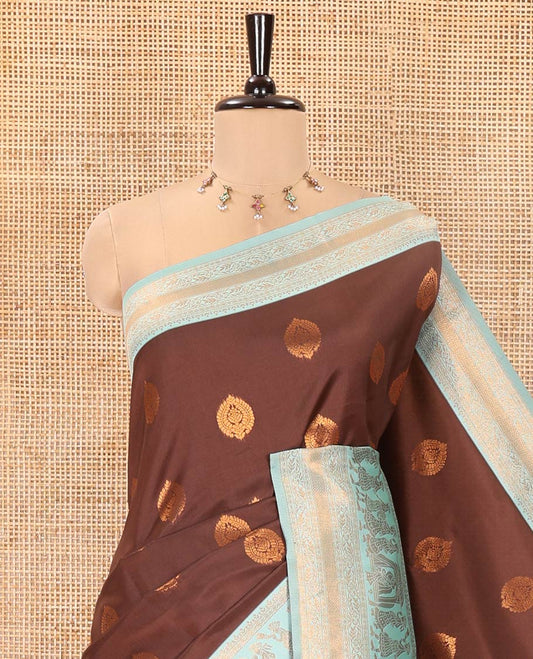 Brown-Green Kanchi Silk Saree, Accentuated with Zari Buttas All Over Its Body, Complemented by Contrast Traditional Zari Border of Wedding Theme Motifs, Grand Pallu and Paired with a Contrast Blouse