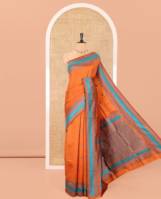 Rust Orange Kanchi Silk Saree, Woven with Floral Thread Buttas All Over Its Body, Complemented by a Contrast Border of Temple Traditional Motifs, Jaal Pallu, and Paired with a Matching Blouse