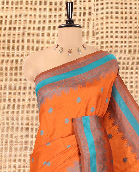 Rust Orange Kanchi Silk Saree, Woven with Floral Thread Buttas All Over Its Body, Complemented by a Contrast Border of Temple Traditional Motifs, Jaal Pallu, and Paired with a Matching Blouse