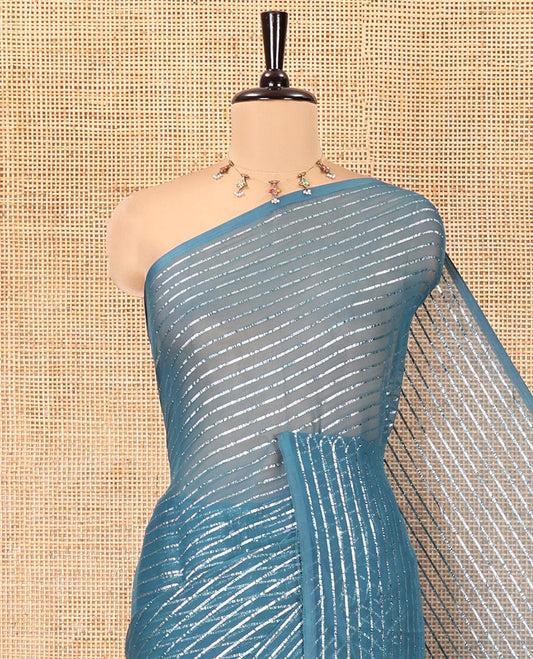 Borderless Blue Chiffon Saree, Gleamed Up with Horizontal Stripes on Its Body, a Self-Pallu, and Has No Blouse