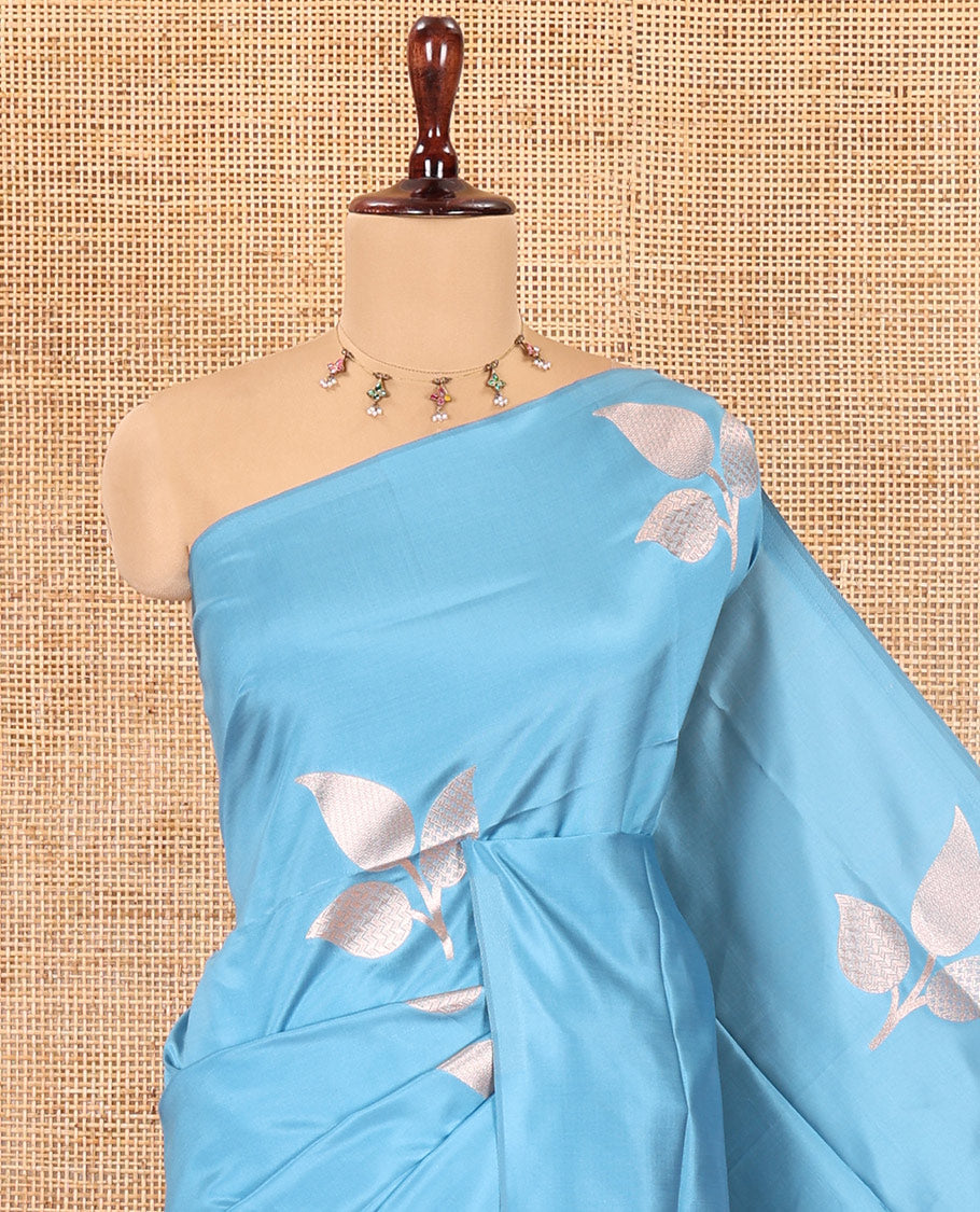 Borderless Blue Elite Soft Silk Saree, Detailed with Leaf Motifs, a Self-Pallu of Floral Designs, and a Matching Blouse
