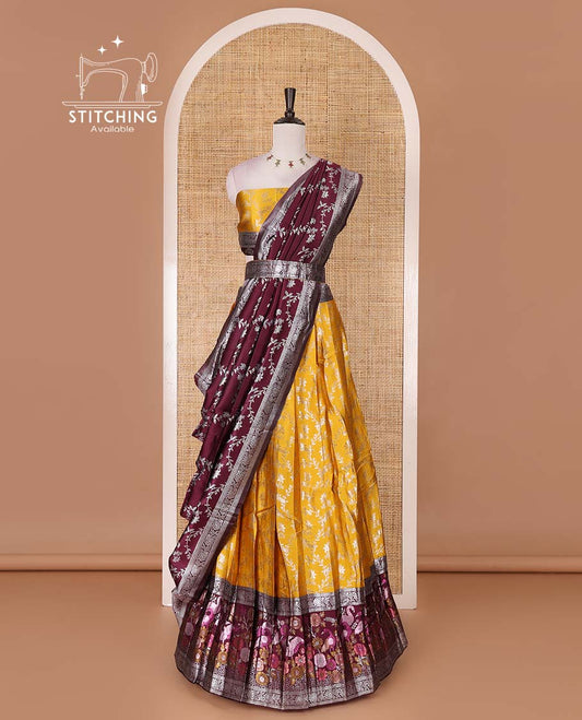 Haldi yellow taffeta silk half saree, floral jaal jacquard skirt, contrast wine zari meenakari style bird border, matching blouse, and floral jaal dhavani