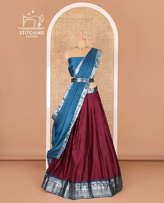 Magenta taffeta silk half-saree, plain with a contrast traditional design bordered skirt, contrast blouse, and traditional zari bordered blouse