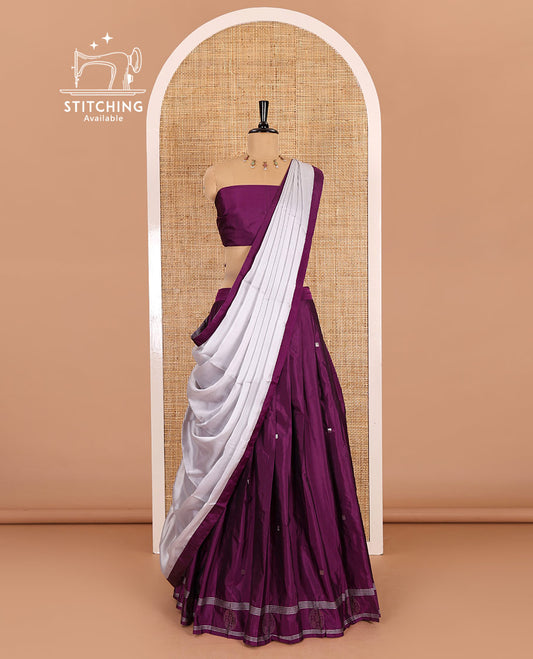 Purple half-saree, buttas with self-bordered taffeta silk skirt, a plain blouse, and a contrast bordered satin georgette dhavani