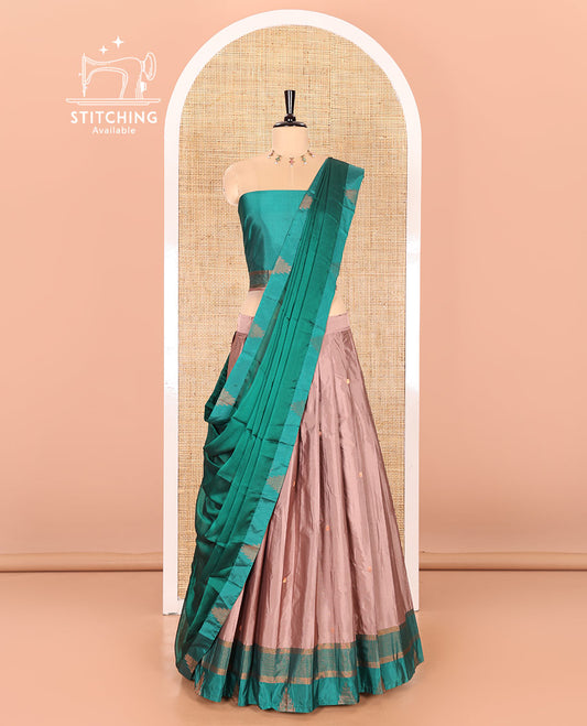 Fawn and green half-saree with buttas with contrast traditional bordered taffeta silk skirt, a matching blouse, and a contrast bordered syska georgette dhavani