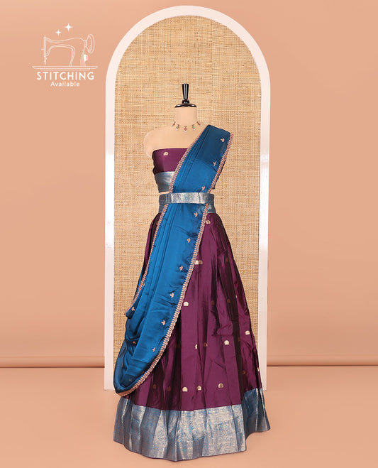 Purple and Blue Semi-Banarasi Half-Saree, Adorned with Zari Buttas on Its Skirt, Complemented by a Contrast Traditional Zari Designs Woven Border, Paired with a Matching Blouse, and a Satin Georgette Embroidered Scallop Dhavani