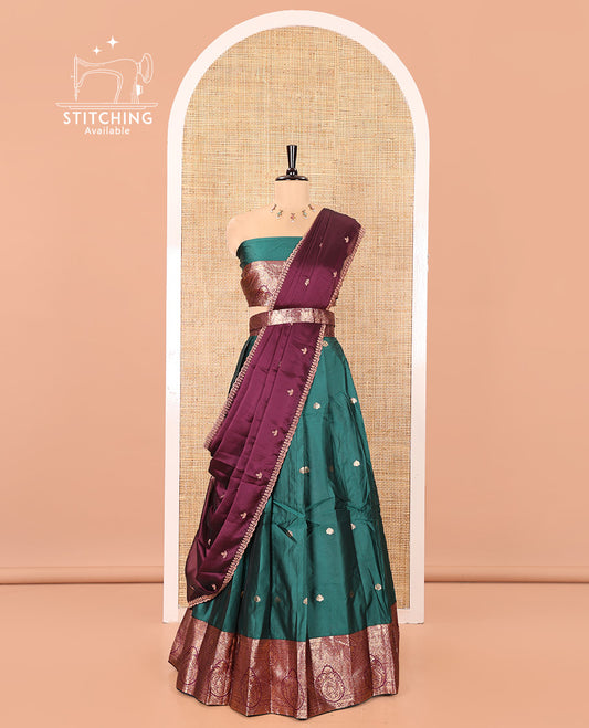 Green and Red Semi-Banarasi Half-Saree, Enriched with Zari Buttas on Its Skirt, Complemented by a Contrast Intricately Zari-Designed Border, Paired with a Matching Blouse, and a Contrast Satin Georgette Embroidered Scallop Dhavani