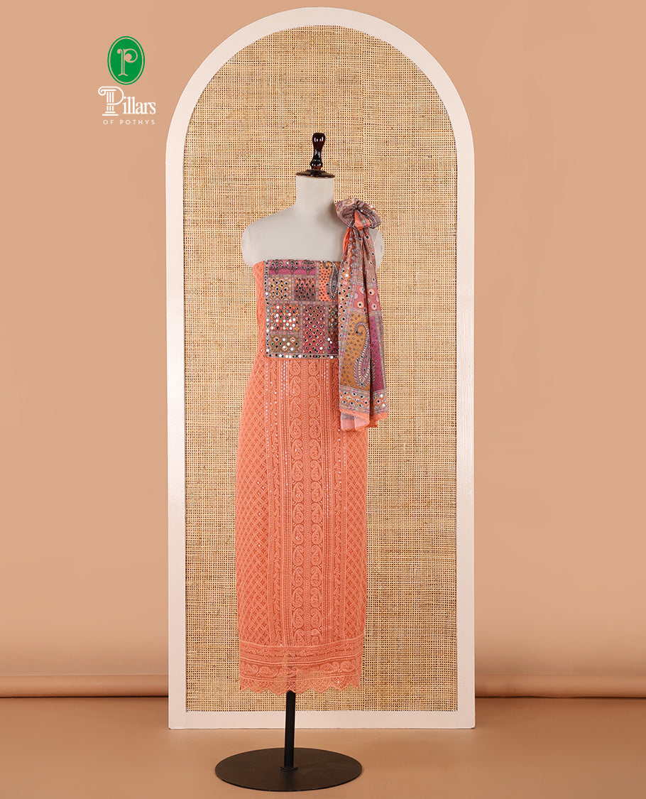 Orange churidar material set, Ajrakh-printed neck with Schiffli embroidery & mirror work georgette top, kalidoscopic-colored dupatta of ajrakh print & mirror embroidery & plain crepe bottom