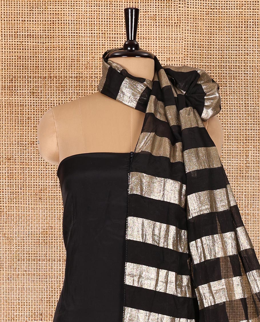 Black material chudidar set, plain with pom-pom tasseled mul chanderi top, a matching bottom, and organza dupatta of stripes