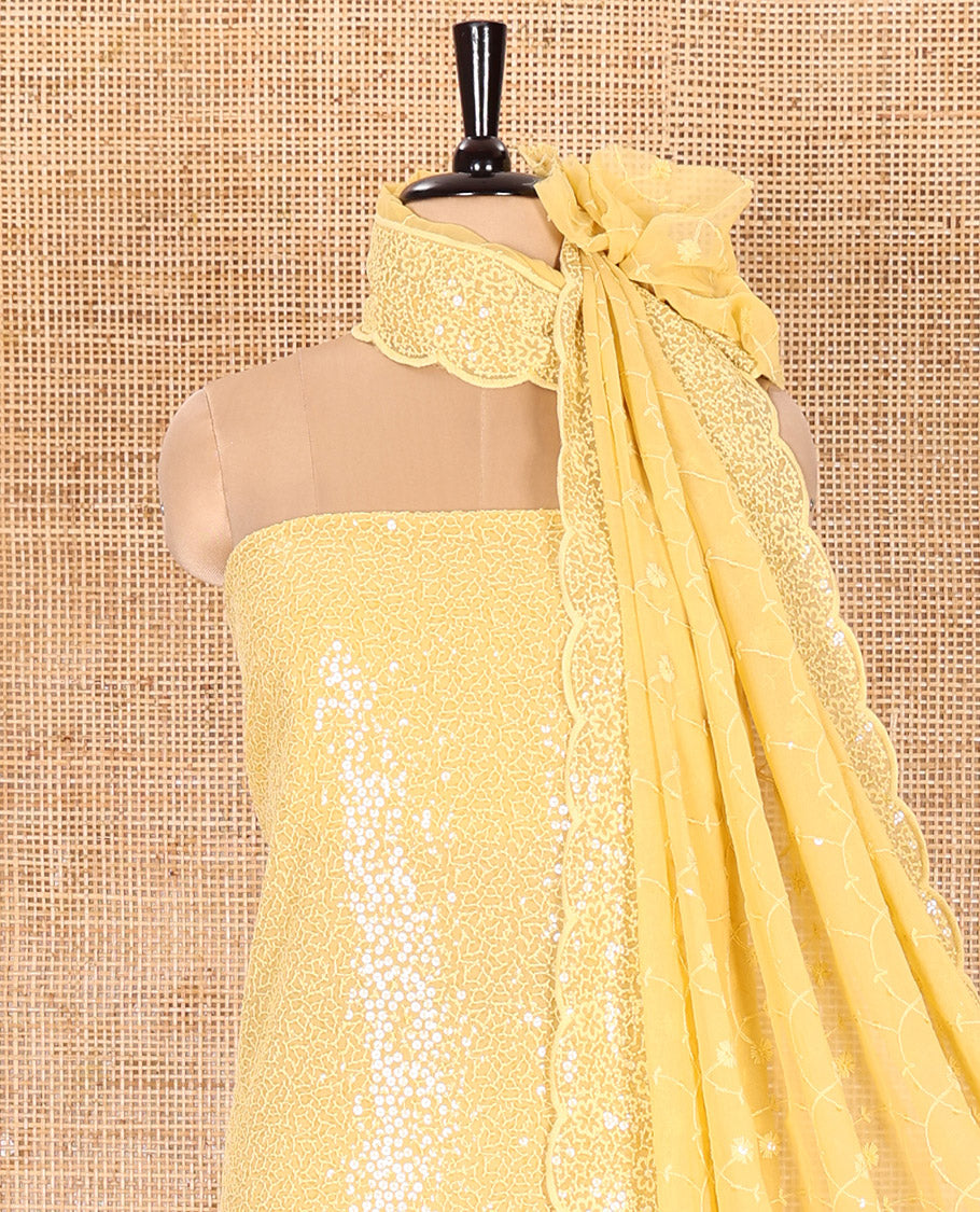 Yellow Material Chudidar Set Features Sequin Embroidered Georgette Top, a Plain American Crepe Bottom, and a Scallop Dupatta Embellished with Floral Vine Embroidery