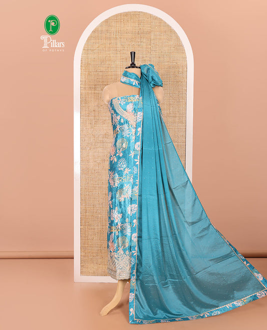 Blue Material Chudidar Set Embellished with Floral-Geometric Printed with Neck Embroidered Chinon Top, Subtly Made Plain Santoon Bottom, and a Chinon Dupatta Featuring Printed Border, and Glitter Dots