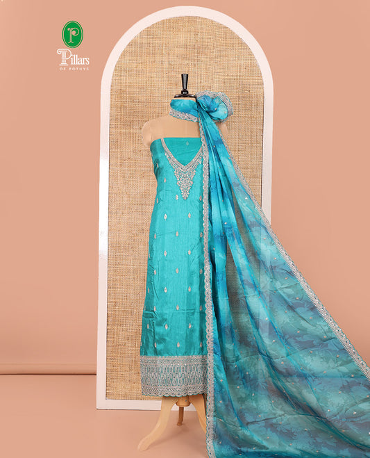 Green Material Chudidar Set Prettified with Intricately Embroidered Muga Silk Top, Subtly Made Plain Santoon Bottom, and a Bemberg Chiffon Dupatta Featuring Floral Printed, and Embroidery