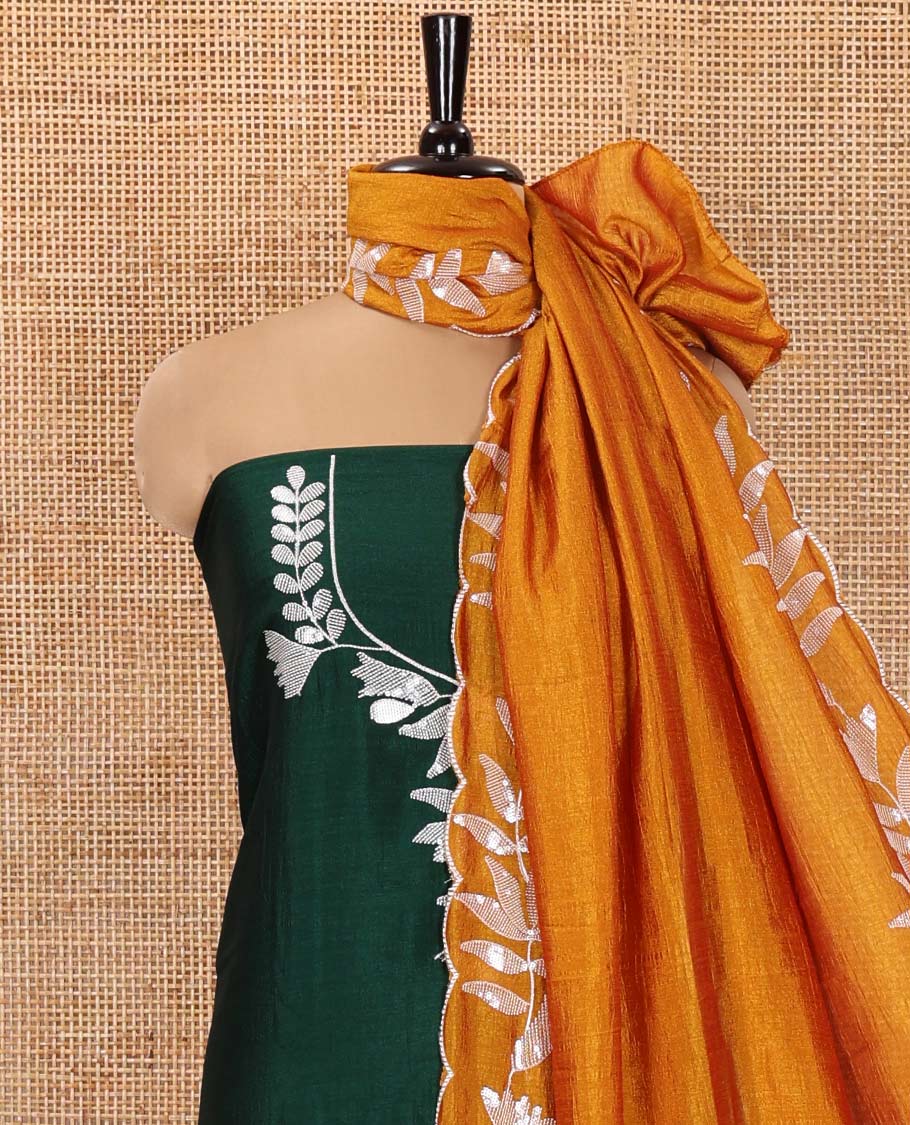 Bottle Green Material Churidar Set, Detailed with Floral Motifs Sequins-Thread Embroidered on Its Vichitra Silk Top, Comes with a Contrast Santoon Bottom, and Paired with a Vichitra Silk Floral Embroidered Scallop Dupatta