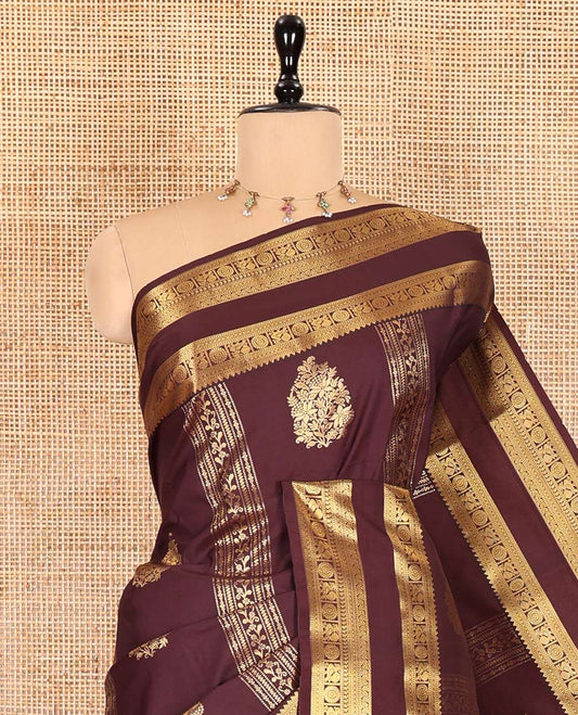 Brown Kanchipuram budget silk saree elevated with zari designs all over its body, complemented by rettai pettu traditional zari design border, Mughal-style intricately woven pallu, and paired with a Matching blouse