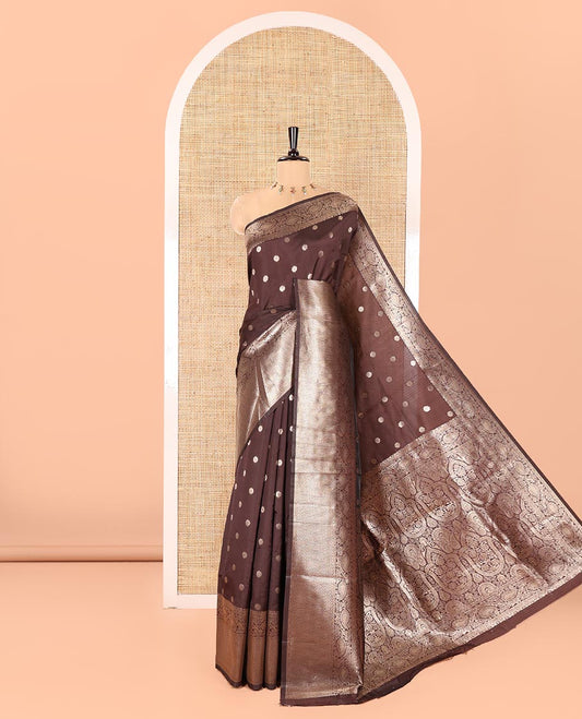 Coffee Brown Litchi Silk Saree, Adorned with Floral Zari Buttas All Over Its Body, Highlighted by a Traditional Zari Border of Paisley Designs, Pallu of Mughal-Style Intricate Designs, and Paired with a Matching Blouse