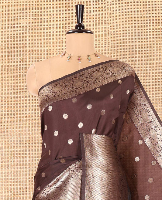 Coffee Brown Litchi Silk Saree, Adorned with Floral Zari Buttas All Over Its Body, Highlighted by a Traditional Zari Border of Paisley Designs, Pallu of Mughal-Style Intricate Designs, and Paired with a Matching Blouse