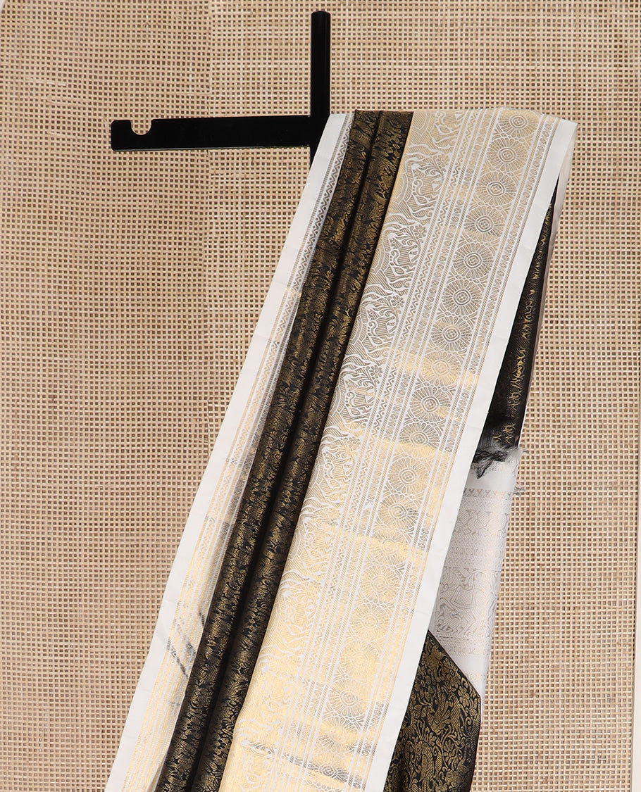 Black jacquard Kanchipuram silk saree, contrast korvai border of manga mokku, neli, banaras, mayil, kuthirai, poun, and poo chakram designs, and zari-rich pallu