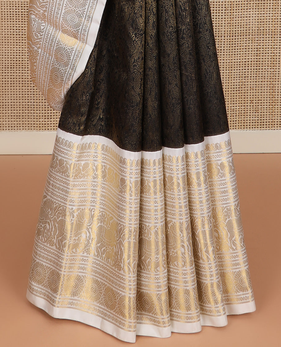 Black jacquard Kanchipuram silk saree, contrast korvai border of manga mokku, neli, banaras, mayil, kuthirai, poun, and poo chakram designs, and zari-rich pallu