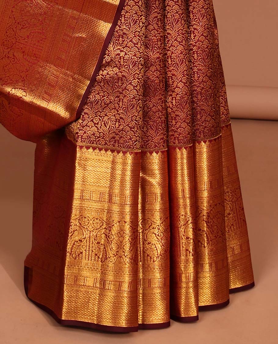 Maroon floral jacquard silk saree with contrast border of rekku,myil,kuyil kann designs & striped floral zari pallu
