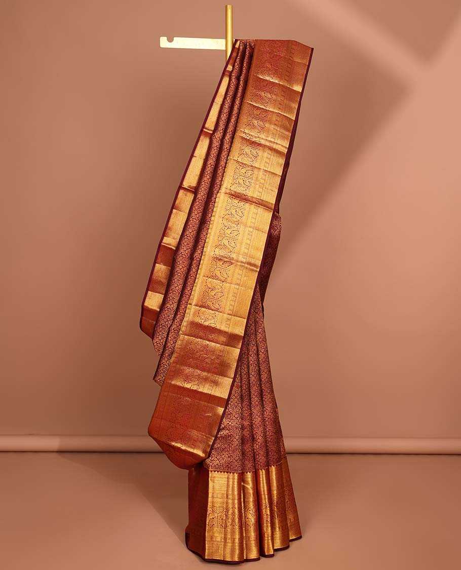 Maroon floral jacquard silk saree with contrast border of rekku,myil,kuyil kann designs & striped floral zari pallu