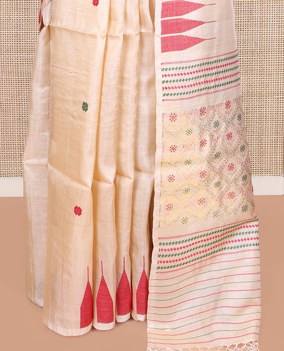 Cream Tussar Silk Saree, Finely Woven with Multi-Color Thread Buttas All Over Its Body, Subtly Sparkled with Temple Border, Pallu Depicts Flower Butta Enclosed Jaal Designs, and Paired with a Matching Blouse