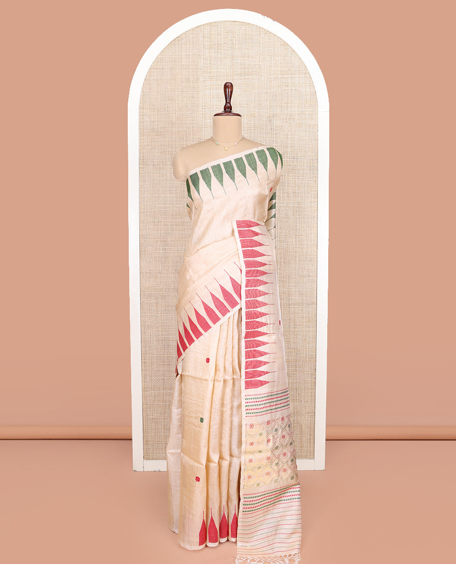 Cream Tussar Silk Saree, Finely Woven with Multi-Color Thread Buttas All Over Its Body, Subtly Sparkled with Temple Border, Pallu Depicts Flower Butta Enclosed Jaal Designs, and Paired with a Matching Blouse