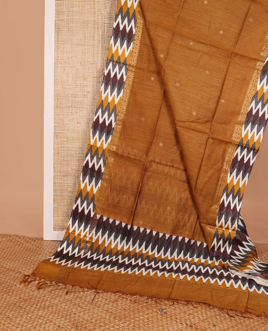 Mustard tussar saree with buttas, contrast pochampally ikkat-style geometric patterned border & pallu