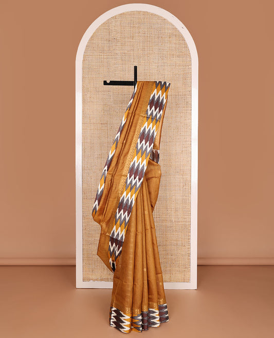Mustard tussar saree with buttas, contrast pochampally ikkat-style geometric patterned border & pallu