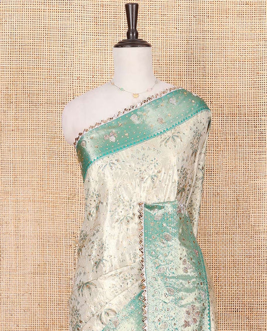 Beige Vastrakala Silk Saree Artfully Detailed with Floral Jacquard and Stone Work, Complemented by Contrast Traditional Zari and Stone Embroidered Scallop Border, Zari-Rich Jaal and Stone Work Pallu, and Paired with Contrast Stone Work Blouse