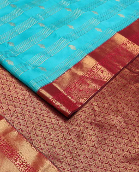 Blue zari buttas and striped Vasundhara silk mix saree, contrast border of thilakam mokku, mayil kann, paisa and paithani-style zari designs, and thilakam steeped pallu