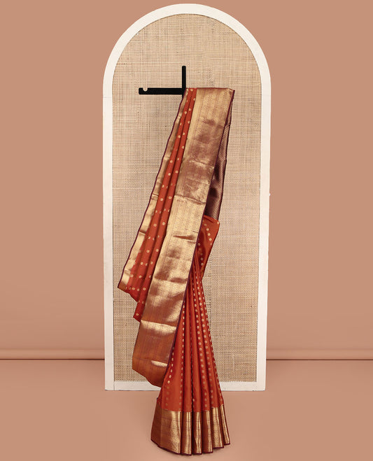 Rust Vasundhara Lite Silk Mix Saree, Elegantly Highlighted with a Kamalam Buttas on Its Body, Complemented by a Contrast Border of Muthu, Vanki, Round Mayil, and Chakram Designs, Gracefully Embellished Pallu, and Paired with a Contrast Blouse