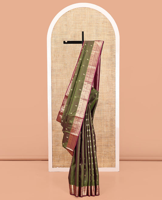 Green Vasundhara Silk Saree, Crafted with Zari Buttas All Over Its Body, Complemented by a Contrast Border of Rekku, Chakram, Neli, and Banaras Designs, Intricately Designed Pallu, and Paired with a Contrast Blouse