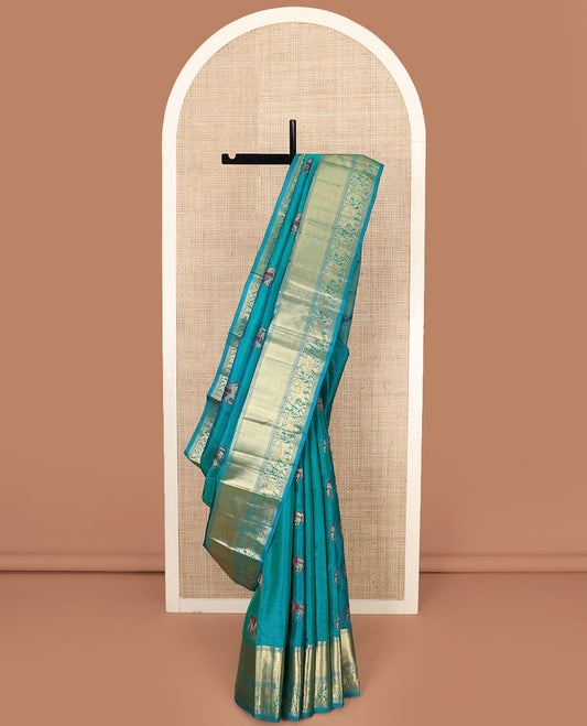 Blue Vasundhara Silk Saree Woven with Yaanai and Kuthirai Meena Buttas, Complemented by a Zari Border of Mayil Kann, Yaanai and Kuthirai Designs, Gleamed-Up Pallu of Zari Designs, and Paired with a Matching Zari-Bordered Blouse