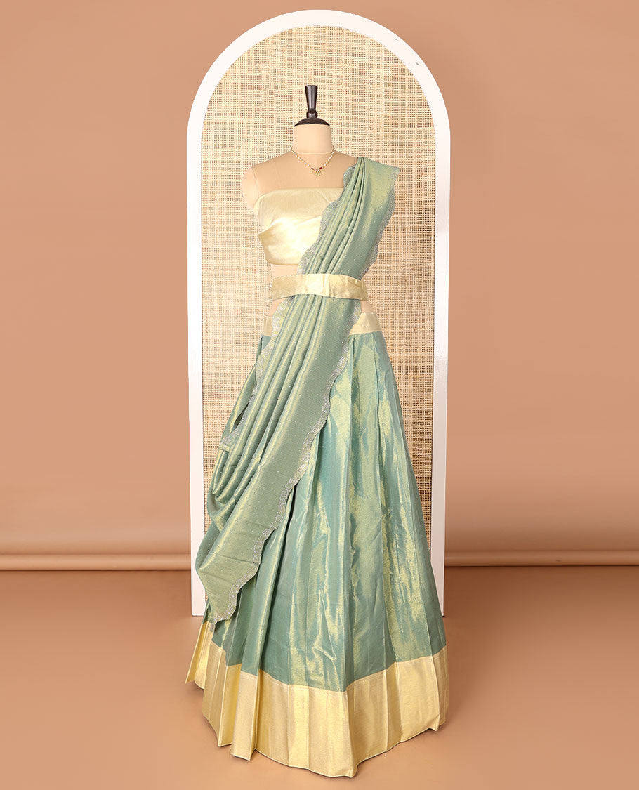 Green art-silk half-saree, plain with contrast bordered skirt, contrast blouse, and a scallop stone work dhavani