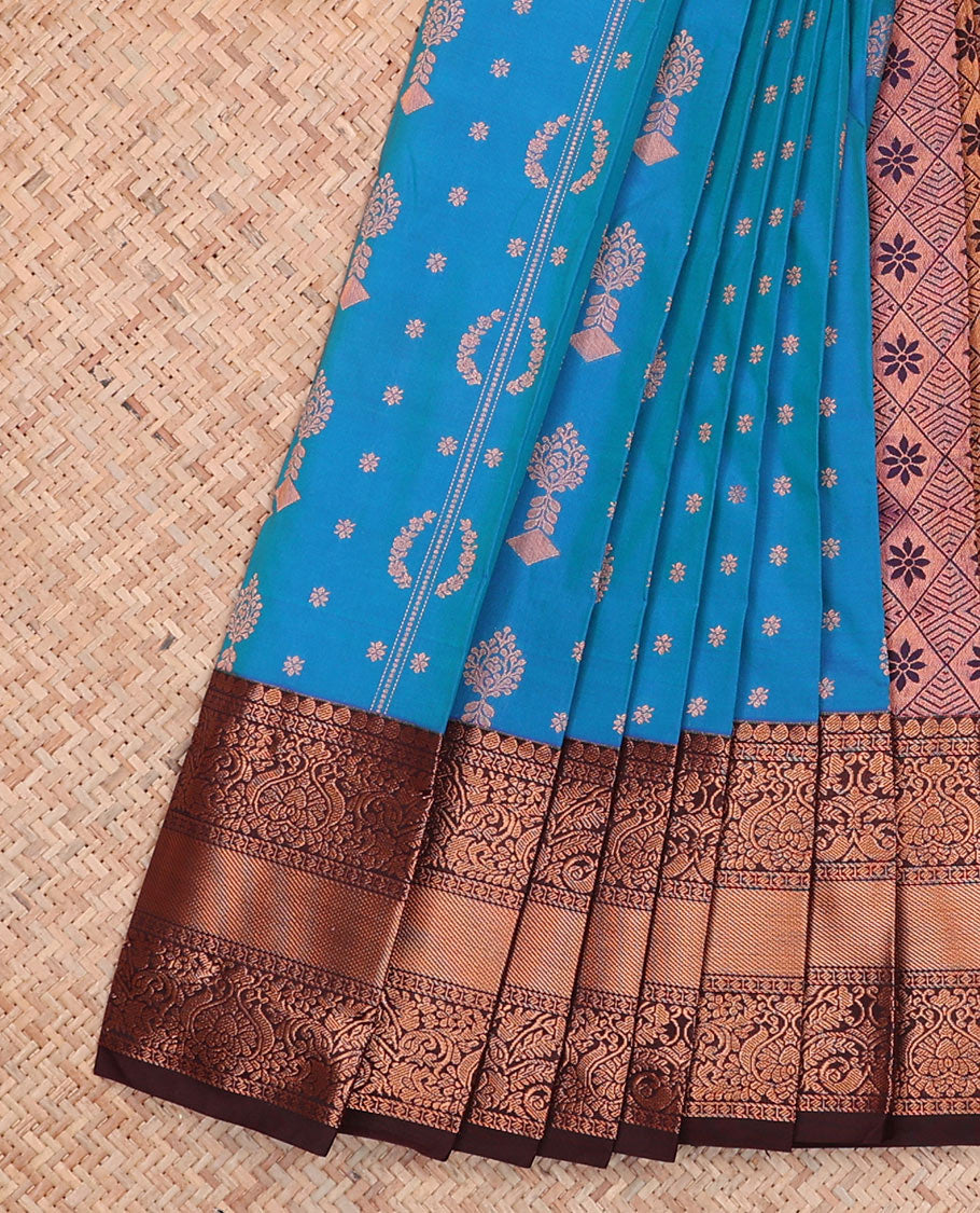 Blue Budget Silk Saree Features Zari Buttas, Complemented by a Contrasting Traditional Zari Design Border, a Pallu Adorned with Jaal Designs, and a Contrasting Zari-Bordered Blouse.