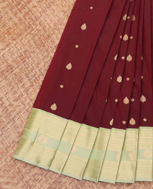 Maroon Budget Silk Saree, Decked Up with Zari Buttas All Over Its Body, Complemented by a Contrast Traditional Zari Design Border, Opulently Embellished Pallu, and Paired with a Contrast Blouse