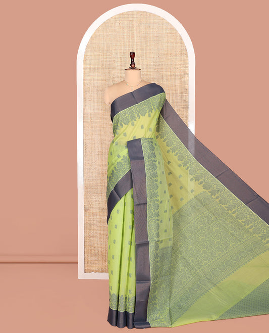 Green Semi-Silk Cotton Saree, Sparsely Woven with Floral Buttas on Its Body, Complemented by Contrast Border, Pallu Steeped with Floral Designs, and Paired with a Matching Blouse
