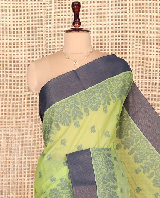 Green Semi-Silk Cotton Saree, Sparsely Woven with Floral Buttas on Its Body, Complemented by Contrast Border, Pallu Steeped with Floral Designs, and Paired with a Matching Blouse