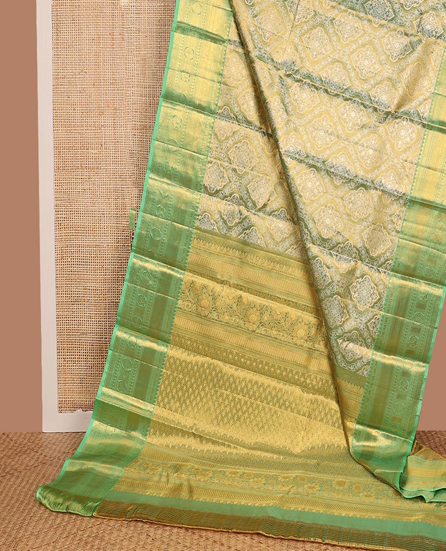 Green Kanchipuram Tissue Silk Saree, Elevated with Jacquard Design on Its Body, Complemented by a Contrast Border of Rekku, Kamalam, Banaras, Muthu, Manga, Mayil, and Mayil Kann Designs, Grand Ogee Pallu, and Paired with a Contrast Blouse