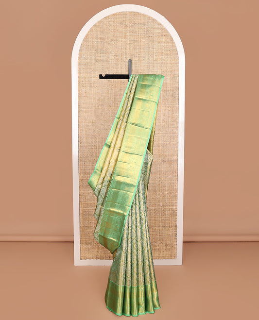 Green Kanchipuram Tissue Silk Saree, Elevated with Jacquard Design on Its Body, Complemented by a Contrast Border of Rekku, Kamalam, Banaras, Muthu, Manga, Mayil, and Mayil Kann Designs, Grand Ogee Pallu, and Paired with a Contrast Blouse