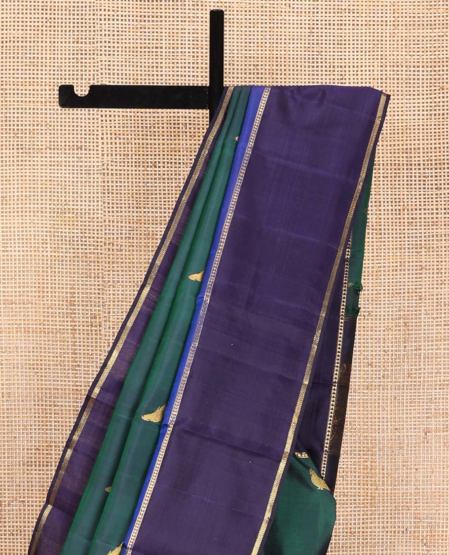 Green kili buttas Kanchipuram silk saree, contrast border of lavangam, muthu, neli, ara bogudi, and kathir stripes, and kathir design pallu